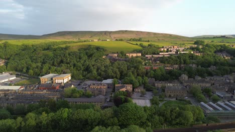 short-fly-over-todmorden-town-center-showcasing-tree-tops-and-old-rural-buildings