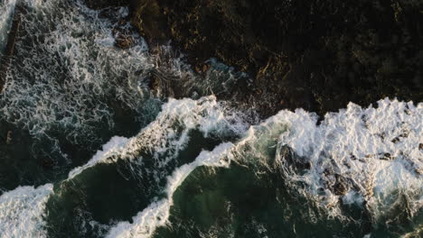 Satellite-top-down-view-of-waves-crashing-against-rocks-at-Sandy-Beach,-Oahu,-Hawaii