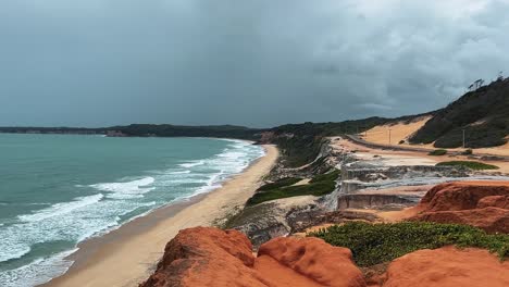 Tilt-up-landscape-shot-of-the-famous-Cacimbinhas-Cliffs-of-the-tropical-Northeastern-Brazil-coastline-near-the-tourist-beach-town-of-Pipa,-Brazil-in-Rio-Grande-do-Norte-during-a-warm-sunny-summer-day