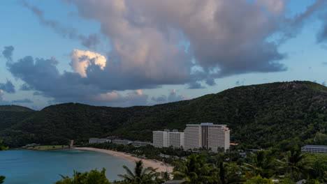 Hamilton-island-reef-view-hotel-timelapse-of-clouds-over-the-sunset-view-from-top-of-the-hill-overlooking-at-the-residential-houses-with-palm-trees-and-sandy-beach