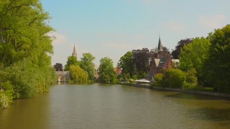 Minnewater-"lake-of-love"-in-sunny-day-on-canal-in-Bruges,-Belgium