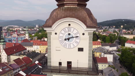 Aerial-orbit-around-clock-tower-of-quaint-Chapel-in-Klagenfurt,-Austria