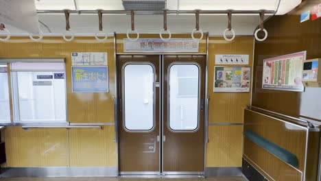 Vintage-looking-Kyoto-subway-interior-with-city-views-outside-window