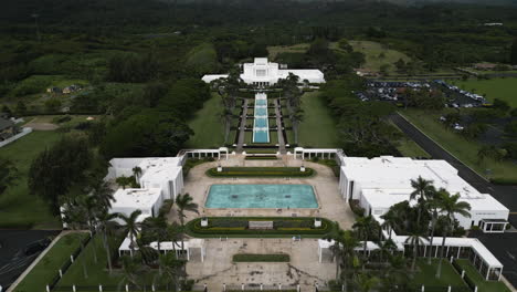 Aerial-reverse-dolly-over-campus-of-Laie-Hawaii-LDS-Temple,-Oahu,-Hawaii