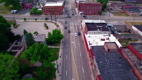 Drone-Flying-Backward-Over-Rockford-downtown-streets-tracking-incoming-traffic-in-the-summer