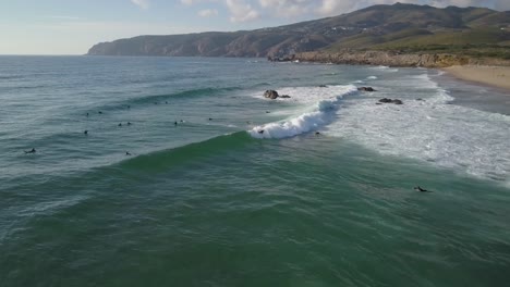 Aerial-shot-of-male-surfer-exercising-alone-in-Atlantic-ocean