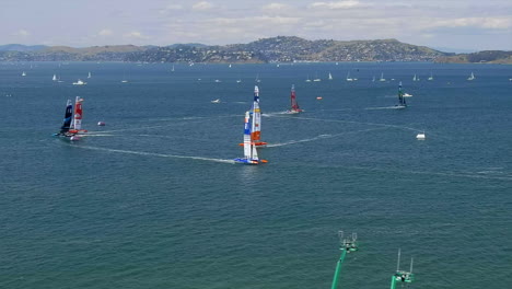 San-Francisco-sailing-grand-prix-aerial-view-tracking-expensive-specialist-yacht-race-teams-under-mountain-landscape