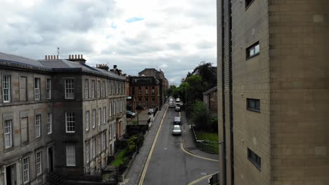 Cityscapes-of-Glasgow-City-quiet-streets-in-Scotland,-UK---Drone-tilt-up-shot