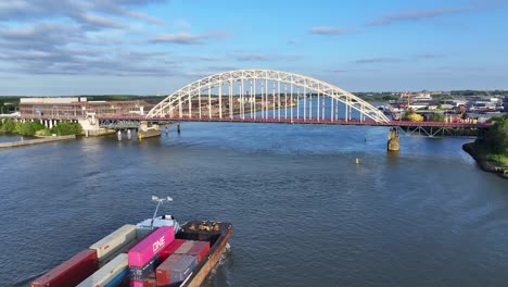 Fully-loaded-container-ship-sailing-on-river-Noord-through-Circle-Alblasserdam