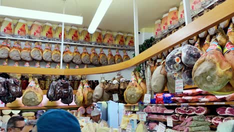A-lot-of-types-of-ham-and-cured-meats-hanging-in-delicatessen-shop-in-italy