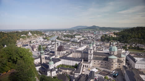 A-wide-open-city-view-of-Salzburg-in-Austria-in-the-morning-with-lots-of-buildings-and-a-blue-sky-with-white-clouds-in-the-background