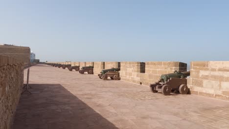 Pan-of-seaside-stone-wall-with-cannons-at-Skala-de-la-Ville,-Essaouira