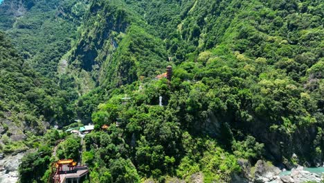 Aerial-view-of-temple-area-with-tower-buildings-and-waterfall-at-Taroko-National-park,-Taiwan