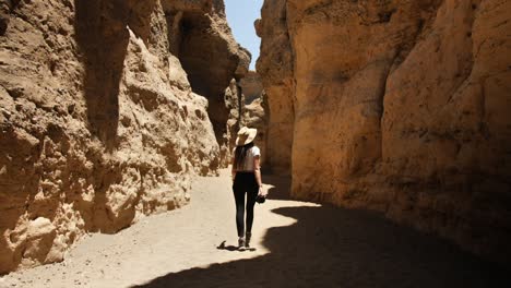 Young-woman-on-her-way-through-a-rocky-landscape-in-the-Namibian-desert