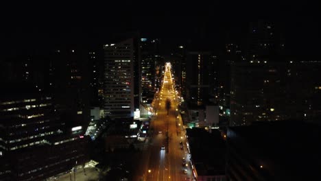 Downtown-Toronto-Canada-empty-road-illuminated-by-lights,-drone-rising-dolly