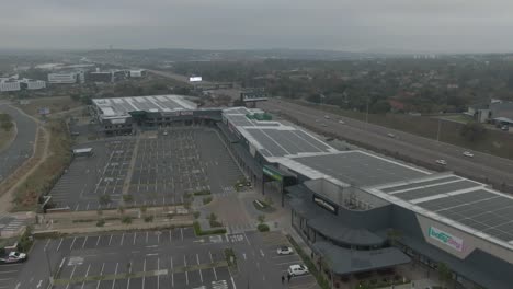 Drone-aerial-of-an-empty-shopping-centre-car-park-with-solar-panels