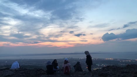 A-bunch-of-muslim-friends-enjoying-the-views-from-the-Arthur-Seat,-Edinburgh