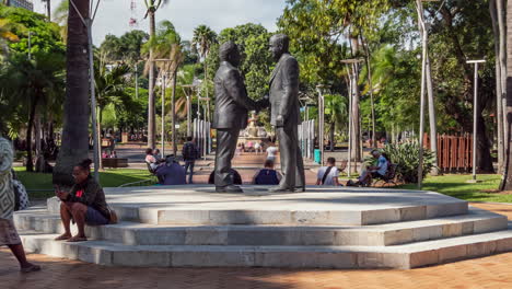 A-statue-of-the-famous-handshake-between-Tjibaou-and-Lafleur-in-Noumea,-New-Caledonia---time-lapse