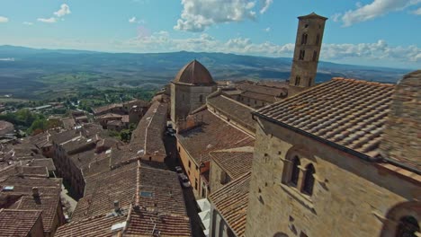 Fast-aerial-over-the-walled-town-of-Volterra,-Province-of-Pisa,-Italy