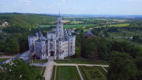 Marvelous-aerial-top-view-flight-Hluboká-Nad-Vltavou-is-a-Fairy-tale-castle-in-Czech-Republic-Europe,-summer-day-2023