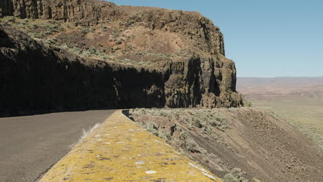 Truck-drives-cliff-road-in-rugged-Frenchman-Coulee-in-WA-Scablands