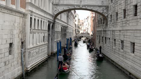 Gondolas-with-Tourists-Going-Past-Under-Bridge-Of-Sighes-On-Rio-del-Palazzo-In-Venice