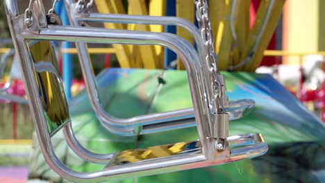 Modern-steel-swing-chair-with-chain-in-kids-playground,-close-up