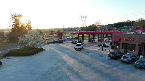Aerial-tracking-of-pick-up-truck-at-Sheetz-gas-station-during-sunset