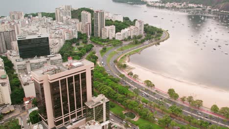 Aerial-Establishing-Shot-of-Botafogo-Beach,-Coastline-in-Rio-de-Janeiro-Brazil,-Main-Avenue,-City-Architecture-and-Sea-Water-Bay