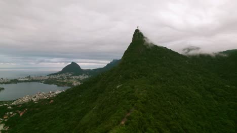 Aerial-view-establishing-in-elevation-of-Corcovado-hill-with-the-statue-of-Christ-the-Redeemer,-Rio-de-Janeiro,-Brazil-on-a-cloudy-day