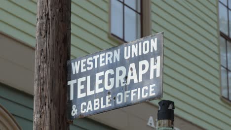 Historic-Western-Union,-metal-sign-in-front-of-a-period-hotel