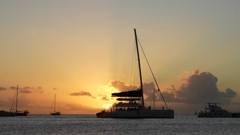 Party-boat-cruising-at-sunset,-in-Saint-Lucia,-Caribbean