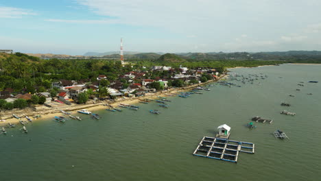 Exotic-township-on-coastline-of-Lombok-island,-aerial-orbit-view