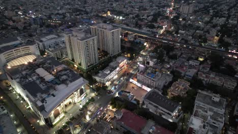 Aerial-view-of-Chennai-City-in-the-evening,-with-footage-of-the-city's-theater,-mall,-busy-streets,-residential-apartments,-and-metro-train