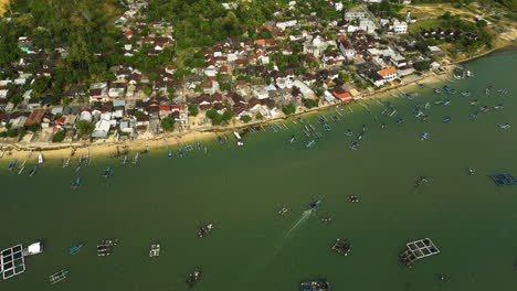 Low-cost-coastal-village-of-Gerepyk-with-many-moored-fishing-boats,-aerial-view