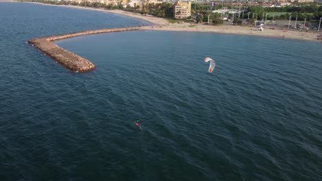 Aerial-view-of-a-person-practicing-kitsurfing-on-a-beach-in-the-city-of-Lecheria,-northern-Anzoátegui-state,-Venezuela