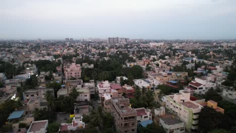An-aerial-view-of-Chennai-City-reveals-a-crowded-neighborhood,-high-rise-structures,-and-metro-rail-construction