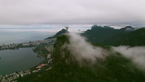 Flyover-establishing-over-the-cloudy-Corcovado-hill-with-Christ-the-Redeemer,-Rio-de-Janeiro,-Brazil