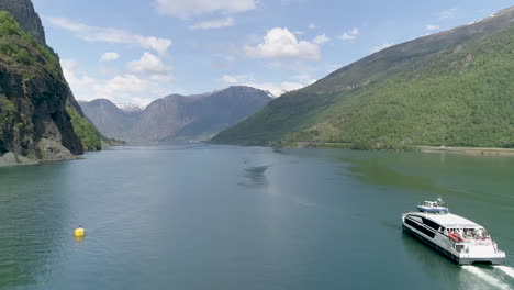 Drone-shot-of-the-Flöm-fjord-,-tourist-boat-going-out-to-the-sea-