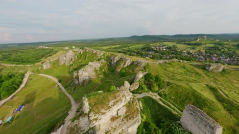 Aerial-FPV-drone-view-of-Olsztyn-Castle-with-mountains-in-Poland