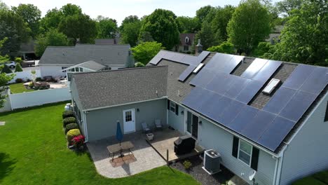 A-drone-zooms-towards-solar-panels-on-a-residential-home-in-small-town-America