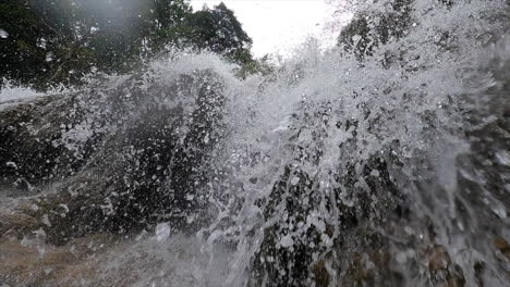 Immersed-in-impressive-waterfall-in-Erawan-national-park,-Thailand