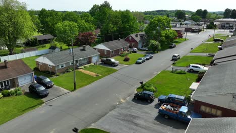 A-drone-flies-parallel-to-a-neighborhood-street-of-a-small-town-in-America