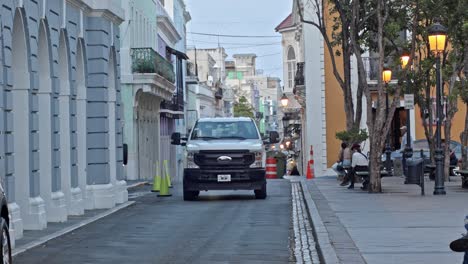 Light-traffic-as-cars-transit-in-Viejo-San-Juan-Puerto-Rico-historical-town-near-Plaza-de-Armas,-during-the-afternoon