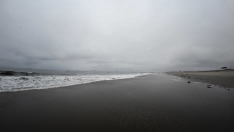 Low-altitude-flight-over-Huntington-Beach,-California-on-a-foggy,-overcast-morning