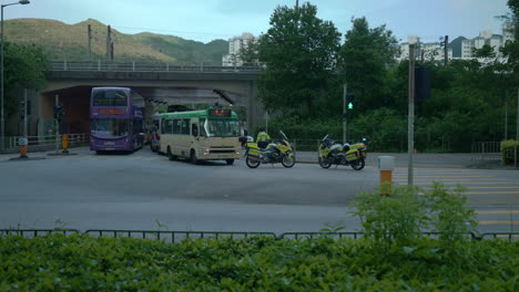Police-patrol-inspecting-car-accident-under-a-flyover-in-Victoria-city,-Hong-Kong,-China