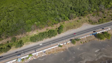 Aerial-drone-view-of-coast,-traffic-highway-and-natural-conservation-forest-next-to-Port-Caldera,-Puntarenas,-Costa-Rica