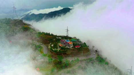 established-shot-of-mountain-hill-view-is-Rishikesh,-Uttarakhand,-India-aerial-drone-camera-moving-forward-above-the-hill,-vehicle-passed-on-the-road-at-hills,-clouded-surrounding-hill-station