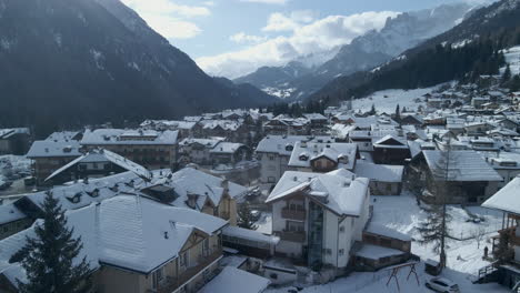 Winter-Village-in-Val-Di-Fassa,-Trentino,-Italy-Amid-Snowy-Alp-Mountains,-Scenic-village-in-snowy-Trentino,-Italy,-with-mountain-views-and-charming-architecture