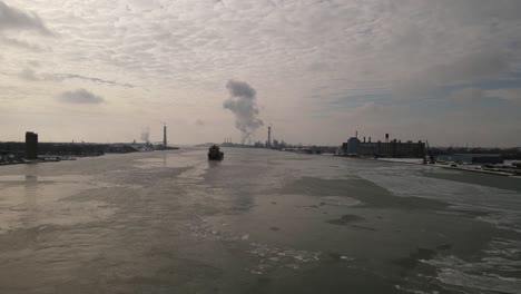Vast-Detroit-river-with-cargo-ship-transporting-goods,-aerial-drone-view